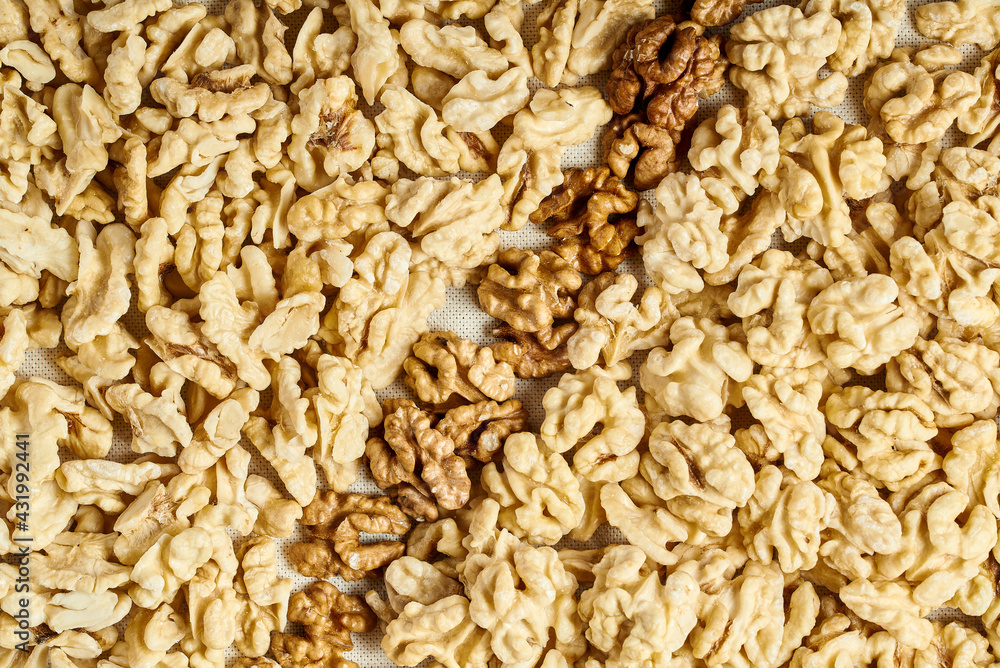 many peeled walnuts of yellow and brown color top view many peeled walnuts of yellow and brown color top view
