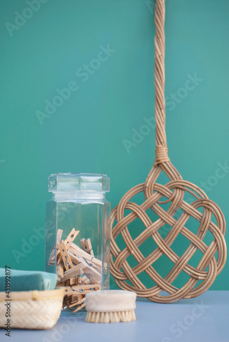 DIY cleaning supplies: retro carpet beater, clothespins in jar, cotton rags and wooden brush
