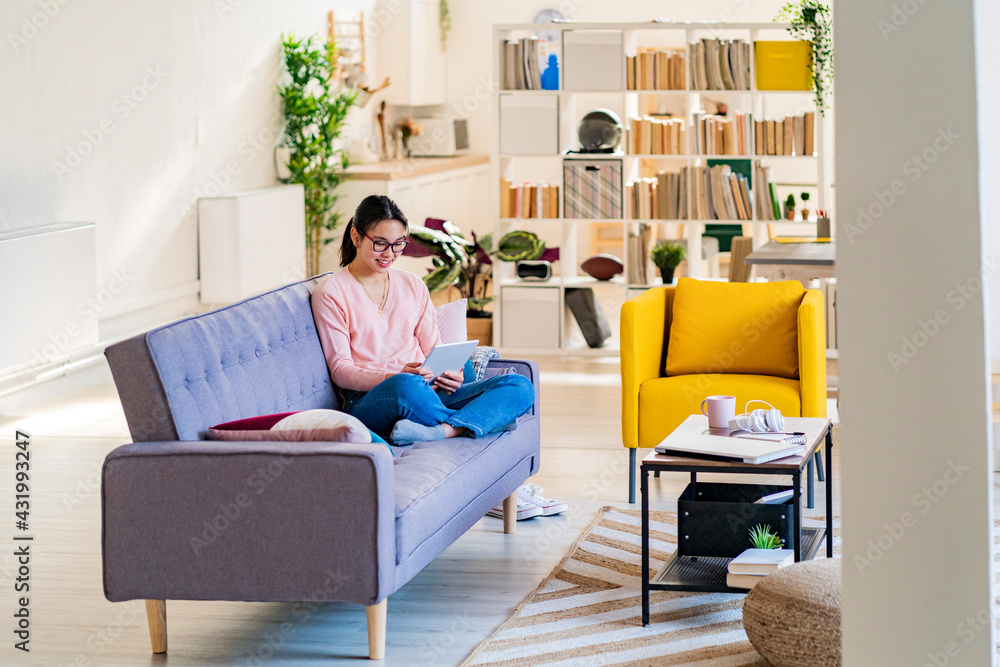 Woman using digital tablet while sitting at home Woman using digital tablet while sitting at home