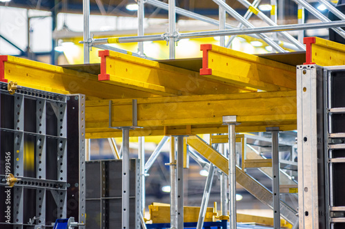 Yellow metal beams on scaffolding props