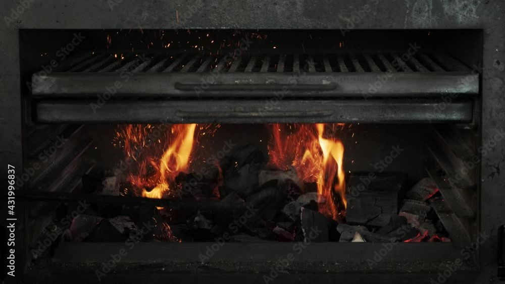 Burning coals in an empty grill. Flames and embers in the grill oven. Fire grilling. Burning coals in an empty grill. Flames and embers in the grill oven. Fire grilling.