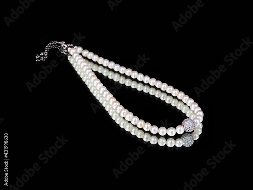 Luxury elegant baroque pearl silver necklace on black mirror background