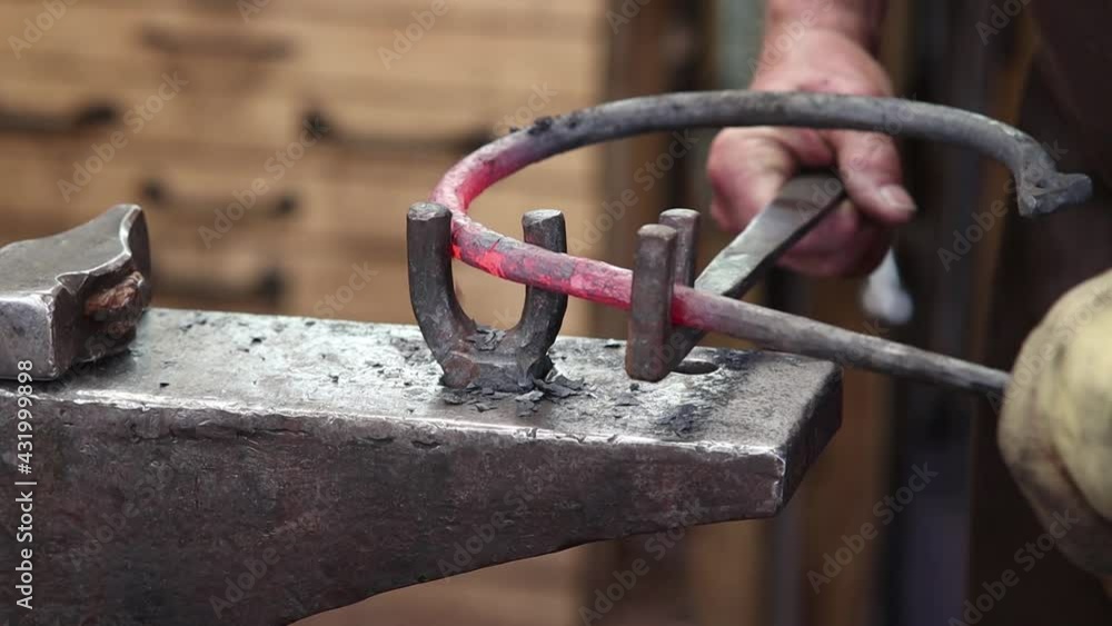 Bending a decorative ring hot at the anvil. Traditional blacksmithing Bending a decorative ring hot at the anvil. Traditional blacksmithing