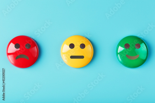 Emotional satisfaction survey icons are Red yellow green on a blue background