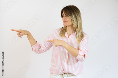 Young woman over isolated white background pointing fingers to the side