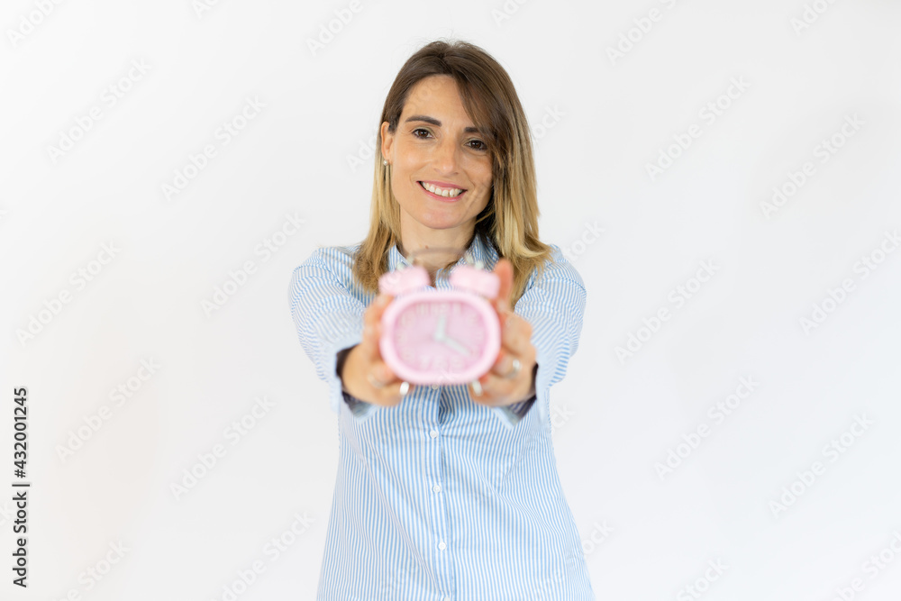Young woman holding alarm clock standing over isolated white background very happy. Young woman holding alarm clock standing over isolated white background very happy.