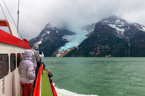 Tourists on a exploration cruise approaching the Balmaceda glacier on the Last Hope Sound inside the Bernardo O Higgings national park in Patagonia, Chile.