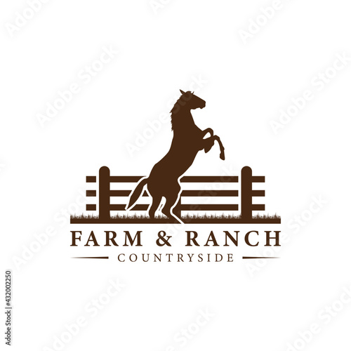Horse silhouette behind wooden fence paddock for vintage retro rustic countryside western country farm ranch logo design