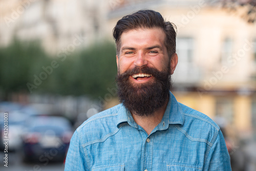 Young handsome bearded hipster man in the city.