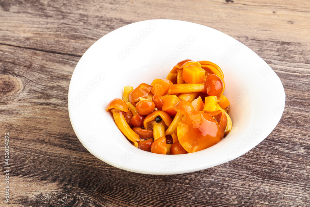 Marinated pickled honey mushrooms in the bowl Marinated pickled honey mushrooms in the bowl