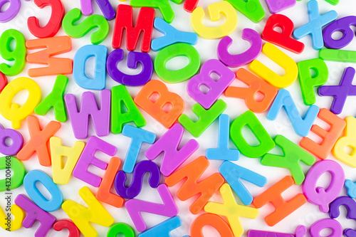 colorful letters are randomly scattered on a white background