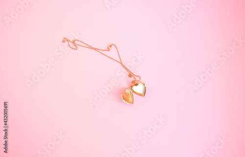 Golden Locket Necklace isolated in pink background