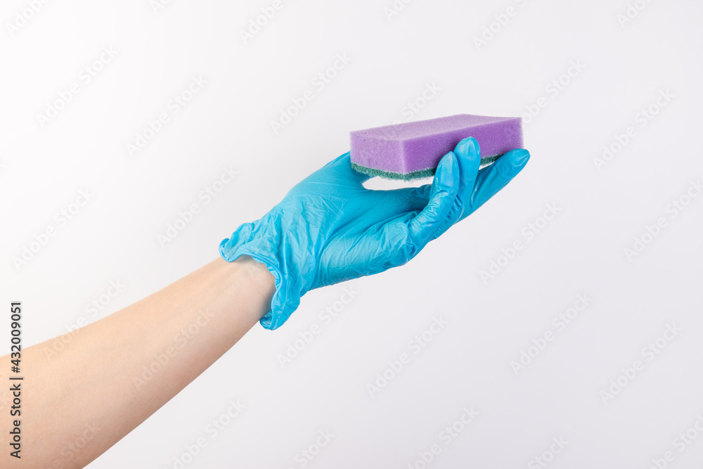 Sponge for washing dishes in female hand. Hand in a latex glove. Woman's hand gesture or sign isolated on white. A hand in a glove holds a sponge for washing and cleaning dishes