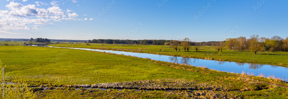 Early spring panoramic view of Narew river valley wetlands and nature reserve seen from Strekowa Gora village near Wizna in Podlaskie voivodship in Poland - obrazy, fototapety, plakaty 