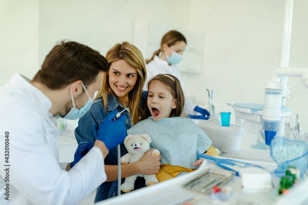 Little girl is not afraid to show teeth to dentist. Prophylactic examinations child at dentist. Little girl is not afraid to show teeth to dentist. Prophylactic examinations child at dentist.