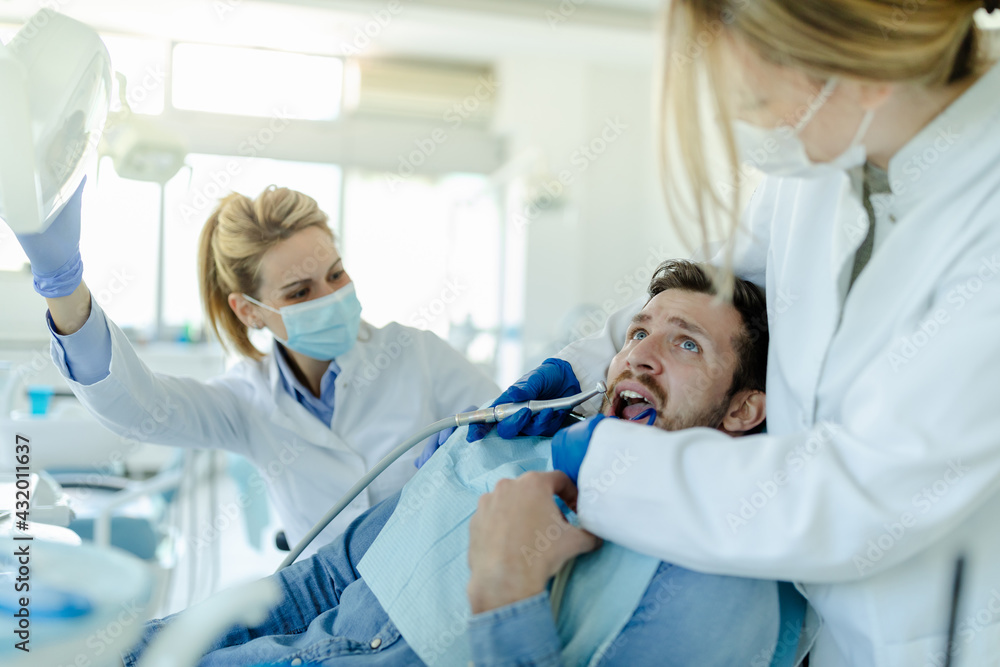 Man having teeth examined at dentists. Man having teeth examined at dentists.