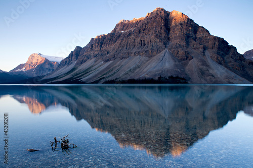 Perfectly calm water made for an ideal mountain reflection during this sunrise at Bow Lake in Banff National Park, Alberta, Canada photo