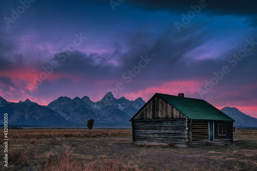 Standalone cabin at sunset in Grand Teton, Wyoming photo