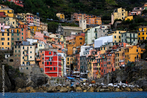 With houses clinging to the slopes of a steep mountain, Riomaggiore in Cinque Terre, Italy, is a mecca for hikers and trekkers. photo