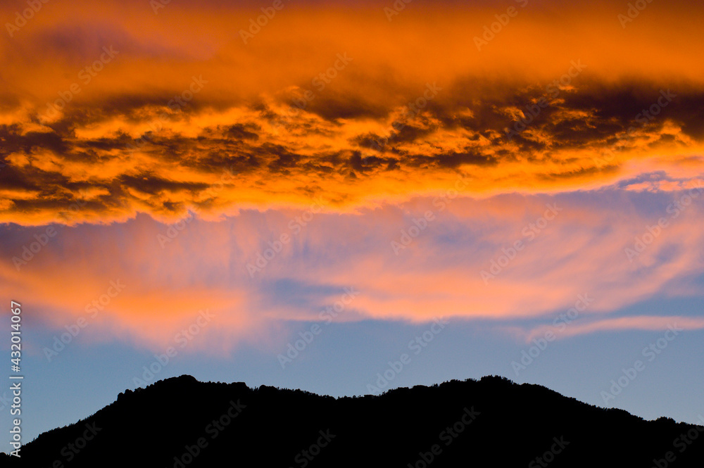 A sunset over the Rocky Mountains is reflected in a lake near Boulder, Colorado A sunset over the Rocky Mountains is reflected in a lake near Boulder, Colorado