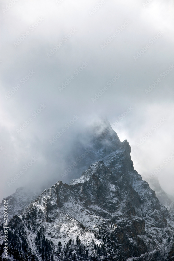 dramatic light and clouds on the Tetons in grand teton national park dramatic light and clouds on the Tetons in grand teton national park