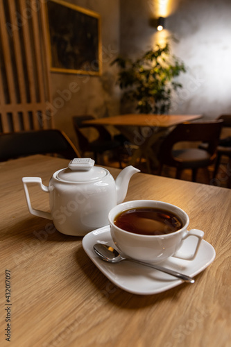 Fototapeta Naklejka Na Ścianę i Meble -  White porcelain tea cup and teapot