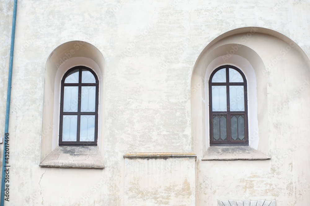 Old facades of a gothic building, doors and windows