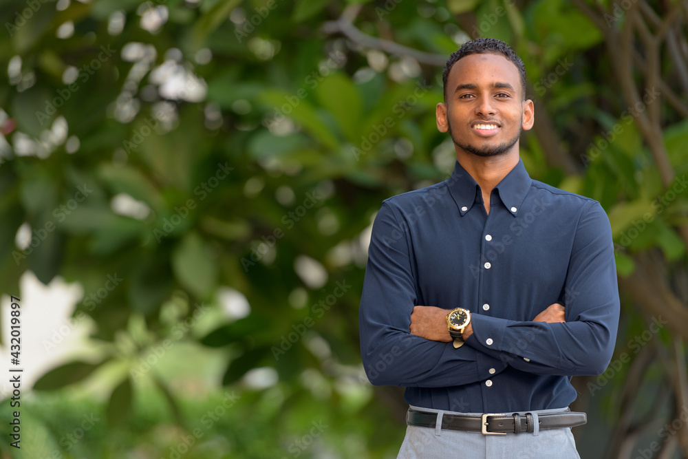 Handsome African businessman outdoors at rooftop garden Handsome African businessman outdoors at rooftop garden