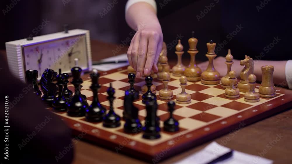 Two chess players man and woman play chess. Debut Accepted Queen's Gambit, King's Gambit, Philidor's Defense. Cinematic filming of a chess game. Antique chess board. This shot can be used for films. Two chess players man and woman play chess. Debut Accepted Queen's Gambit, King's Gambit, Philidor's Defense. Cinematic filming of a chess game. Antique chess board. This shot can be used for films.