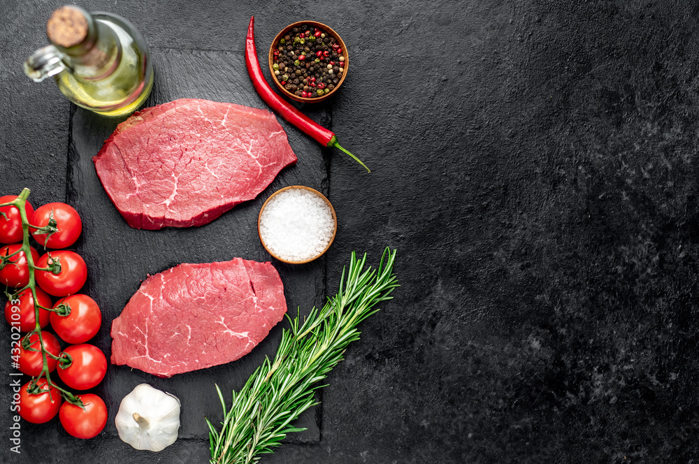 raw beef steak with spices on stone background with copy space for your text raw beef steak with spices on stone background with copy space for your text