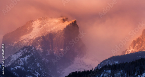 Hallet Peak, in Rocky Mountain National Park, at sunrise as a winter snowstorm is beginning to affect the mountains along the Front Range.
