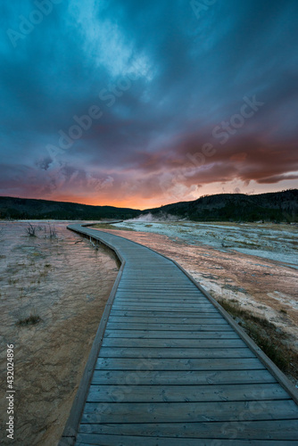 Wallpaper Mural Evening storm clouds gather over a boardwalk in Biscuit Basin, Yellowstone National Park. Torontodigital.ca