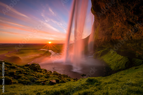 A waterfall in Iceland with colorful skies, during the midnight sun. photo