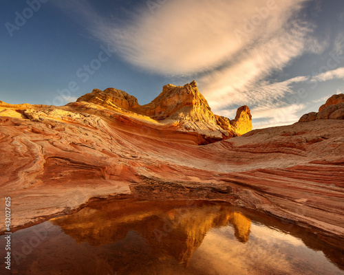 Beautiful striated sandstone reflected in a rain pool in this remote region of the Arizona desert.