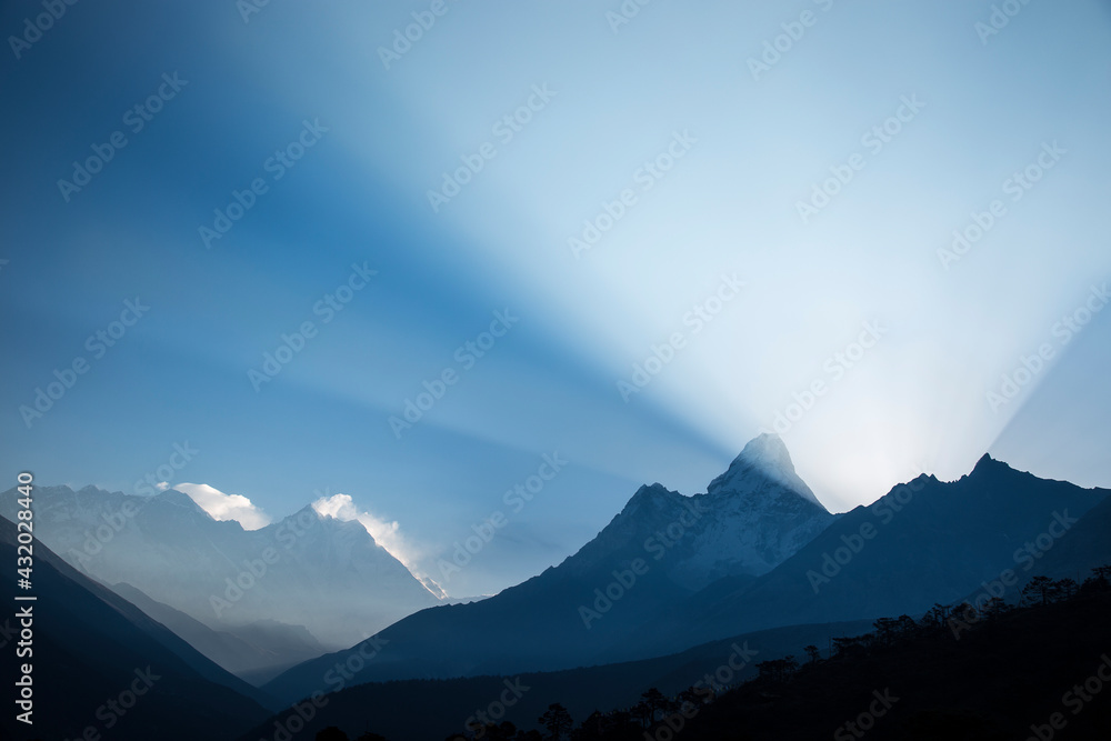 © Tandem Stock - The peaks of Nuptse, Everest, Lhotse, and Ama Dablam and a large beam of light as viewed from the village of Tengboche in Nepal. © Tandem Stock - The peaks of Nuptse, Everest, Lhotse, and Ama Dablam and a large beam of light as viewed from the village of Tengboche in Nepal.