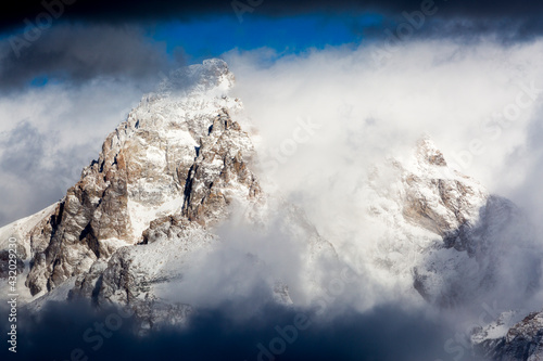 Mount Owen and the Grand Teton are coated in a fresh layer of snow from an early winter storm in Grand Teton National Park, Wyoming. photo