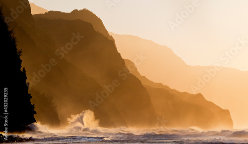A wave crashes along the rocky shores of Ke'e Beach on Kauai's Na Pali Coastline. photo