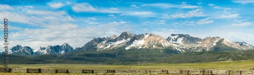 The Sawtooth Mountain Range with a fence in the foreground photo