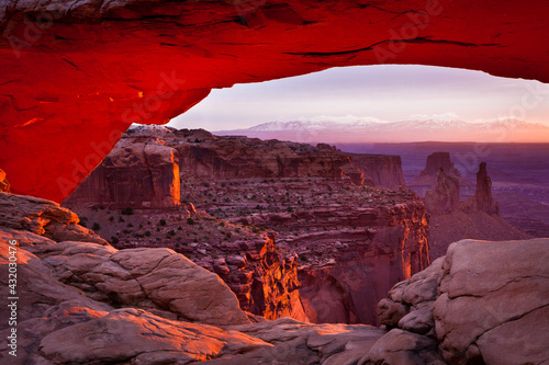 Sunrise lights up the bottom of Mesa Arch in Canyonlands National Park, Utah. photo