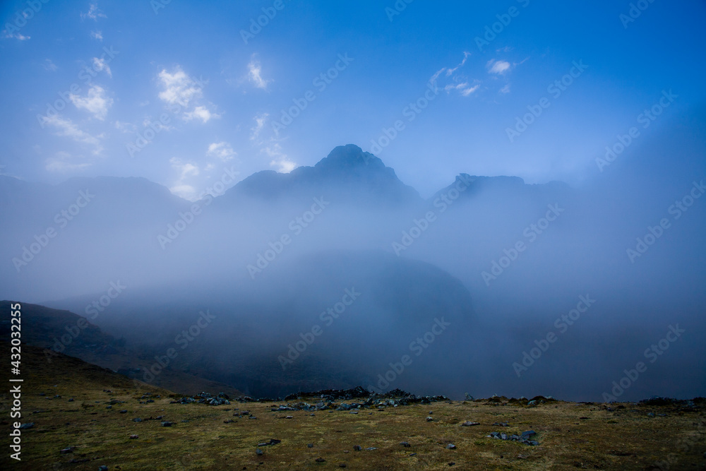 Early morning clouds envelop the high peaks and deep valleys in Bolivia's Apolobamba Range during winter. Early morning clouds envelop the high peaks and deep valleys in Bolivia's Apolobamba Range during winter.