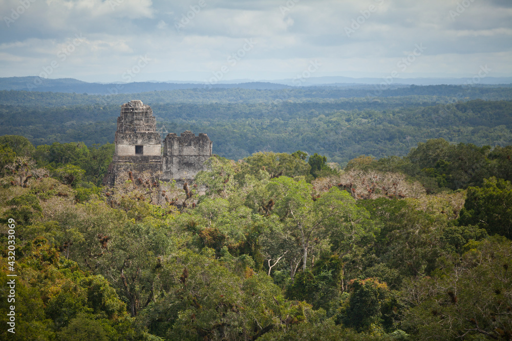 An ancient pyramid emerges from the forest at the Mayan Ruins of Tikal, Guatemala. An ancient pyramid emerges from the forest at the Mayan Ruins of Tikal, Guatemala.