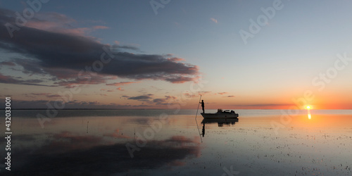 A boater uses a push pole to navigate the mangrove flats of Florida Bay within Everglades National Park, Florida.