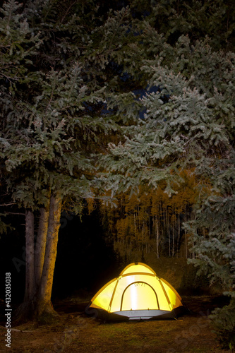 Illuminated dome tent at a campsite in the upper Middle Fork of the Dolores River, San Juan Mountains, Colorado. photo