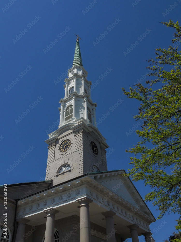 Ornate church bell tower against a beautiful blue sky.
