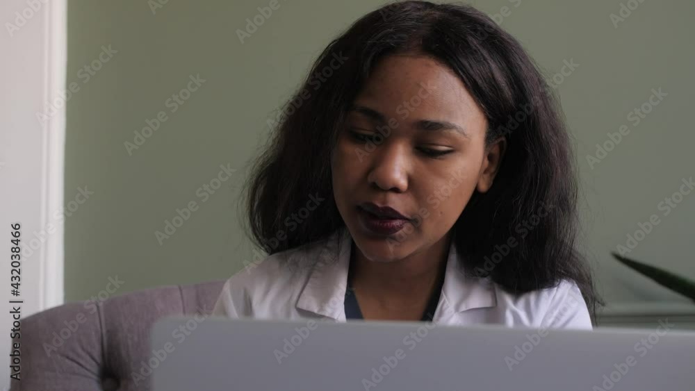 Black female doctor. webiran of doctors. Telemedicine the use of computer and telecommunications technologies for the exchange of medical information Black female doctor. webiran of doctors. Telemedicine the use of computer and telecommunications technologies for the exchange of medical information