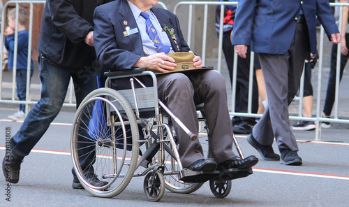 Photography Middle aged men marching one of them is in a wheel chair