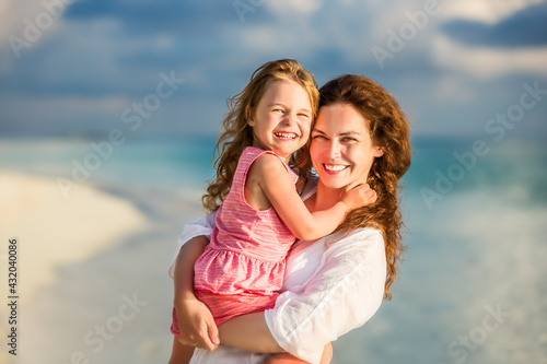 Portrait of happy mother and little daughter on sunny beach on Maldives at summer vacation © sborisov
