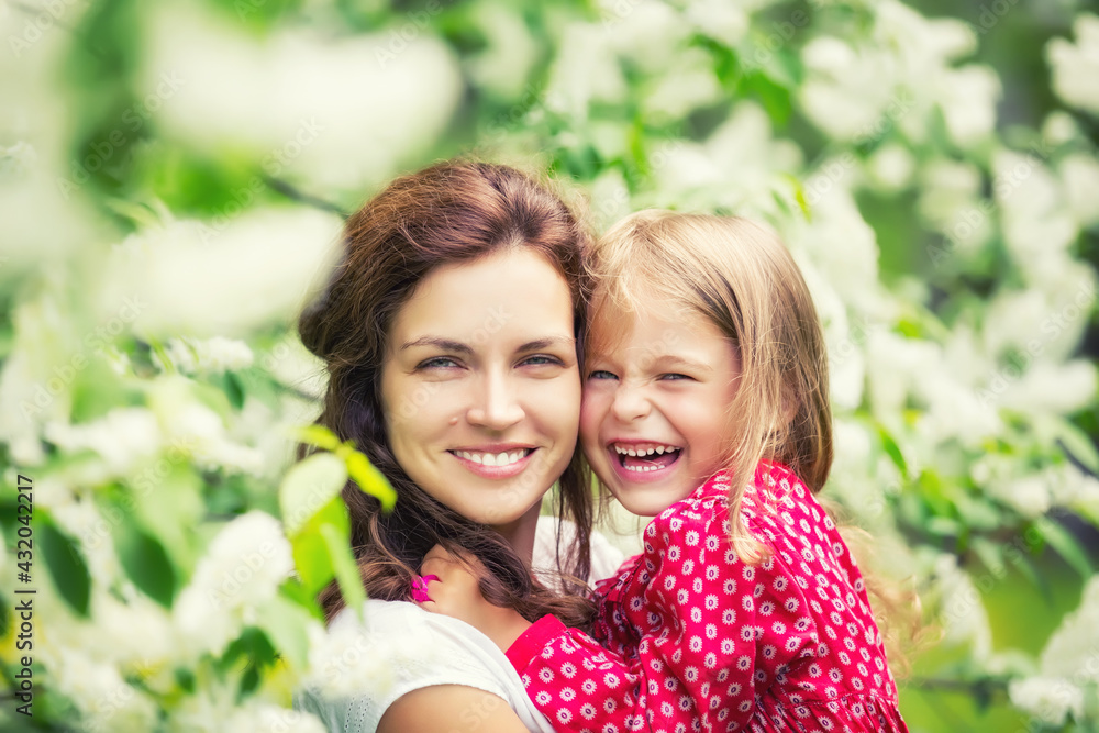 Portrait of happy mother and little daughter in spring park Portrait of happy mother and little daughter in spring park