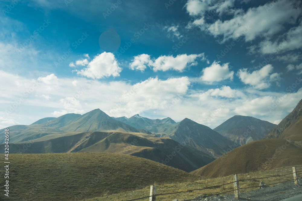 Panorama overlooking the mountains in the clouds. Landscape of the Caucasus Mountains. Fall. Day Georgia. Panorama overlooking the mountains in the clouds. Landscape of the Caucasus Mountains. Fall. Day Georgia.