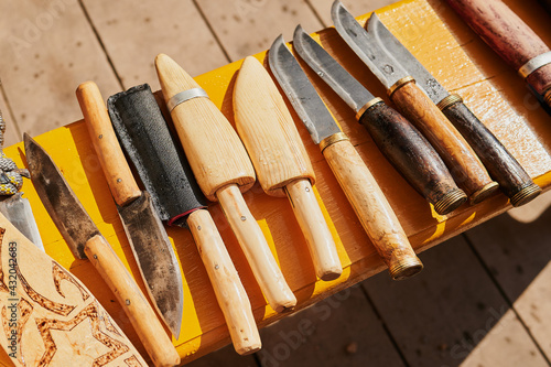 close up of many kinds of different rustic vintage knifes long time ago for cutting and hutting an animal. photo